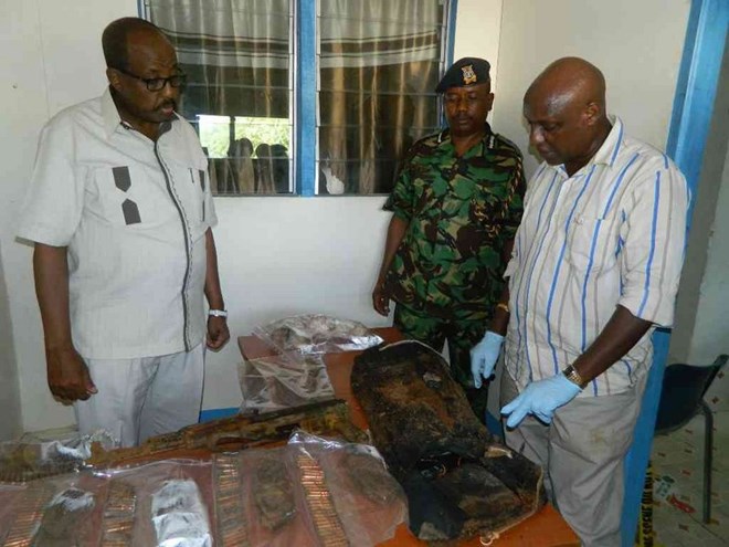 North Eastern regional coordinator Mohamud Saleh and police regional commander Edward Mwamburi inspect the deadly weapons that were found buried outside a commercial residential house in the outskirts of Garissa town. Saleh thanked members of the public for volunteering information on suspected criminals