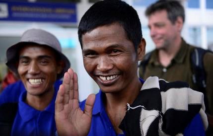 Sailors who had been held hostage by pirates for more than four years, smile as they arrive at the airport in Nairobi, Kenya Sunday, Oct. 23, 2016, after being released in Somalia on Saturday. A Somali pirate said Saturday that 26 Asian sailors held hostage for more than four years had been released after a ransom was paid, and international mediators said it "represents the end of captivity for the last remaining seafarers taken hostage during the height of Somali piracy." (AP Photo)