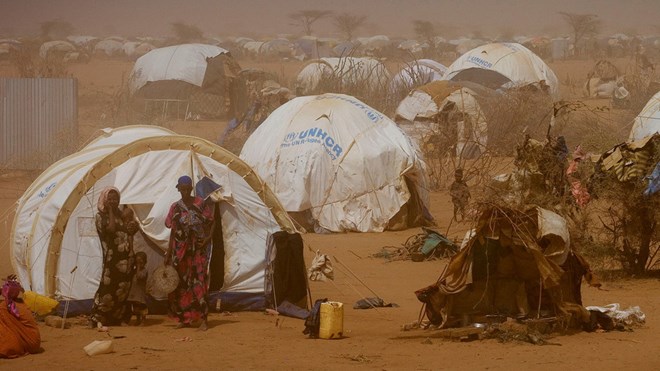 FILE PHOTO: Women and children stand outside temporary tents at a refugee camp near the Kenya-Somalia border. /UNICEF