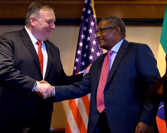 In this Tuesday, Feb. 18, 2020 file photo, U.S. Secretary of State Mike Pompeo, left, shakes hands with Ethiopia's Foreign Minister Gedu Andargachew, during a joint press conference at the Sheraton Hotel, in Addis Ababa, Ethiopia. In an interview with The Associated Press Friday, June 19, 2020, Ethiopia's Foreign Minister Gedu Andargachew declared that his country will go ahead and start filling the $4.6 billion Grand Ethiopian Renaissance Dam next month, even without an agreement with Egypt and Sudan.  POOL PHOTO VIA AP, FILE / ANDREW CABALLERO-REYNOLDS