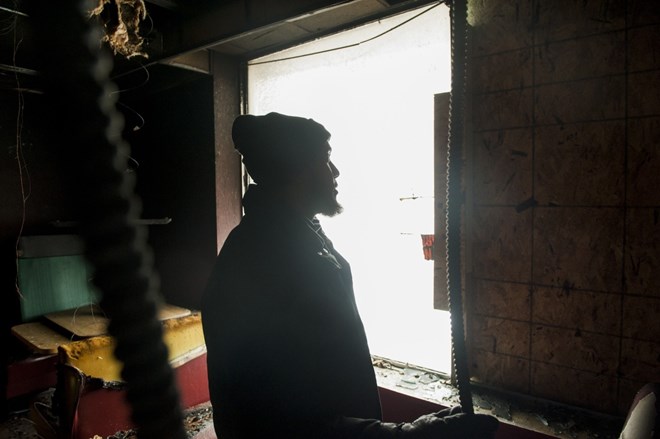 Abdulaziz Moallin stands in the wreckage of Juba Coffee and Restaurant, the restaurant he co-owned, after it was burned in an act of arson on the day Donald Trump said he would temporarily ban Muslims from entering the country. (Andrew Cullen/For The Washington Post)