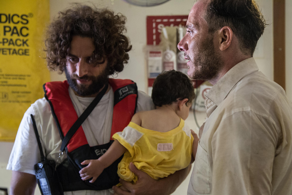 Palestinian Mohamed (R) rescued his one-year-old daughter Azeel when the boat he and his family were in with other migrants capsized in the Mediterranean 05 August. Mohamed's daughter was already under water but he managed to reach out for her. His wife also survived.