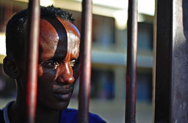 A prisoner looks through bars, at the prison in Garowe, Puntland state, in northeastern Somalia, on December 14, 2016. The prison facilitates the rehabilitation of convicted Somali pirates and suspected Al-Shabaab jihadists. (MOHAMED ABDIWAHAB/AFP/Getty Images)
