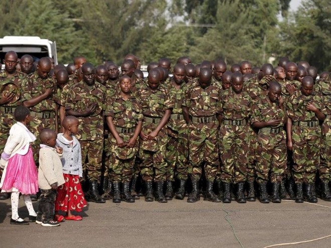 Children watch as members of the Kenya Defence Forces attend prayers to pay respects to the Kenyan soldiers serving in the African Union Mission in Somalia (AMISOM), who were killed in El Adde during an attack, at a memorial mass at the Moi Barracks in Eldoret, January 27, 2016. Photo/REUTERS