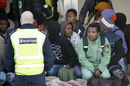 Migrant minors queue to take a bus at the start to their transfer by French authorities to reception centres across the country at the end of the dismantlement of the camp called the "Jungle" in Calais, France, November 2, 2016.