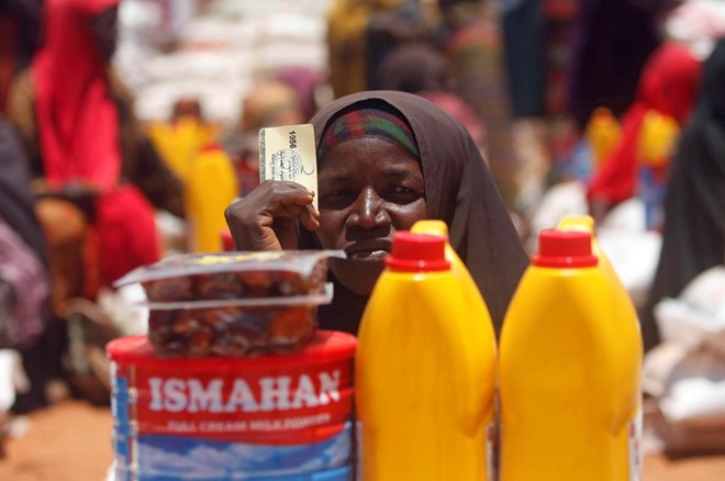An internally displaced Somali woman receives basic food supplies at a distribution center organized by a Qatar charity in Baidoa on April 9. Photo by Feisal Omar/Reuters