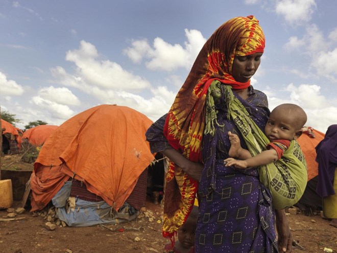 Kaltun Aliyow Mumin, 28, with her daughter Sahra Haret is two years old. They are living in Dusta Camp in Baidoa, they moved here when their savings ran out and their goats died. Their goats were the main source of income. They want to return to their lan