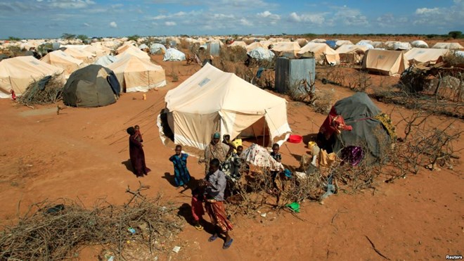 FILE - Refugees stand outside their tent at the Ifo Extension refugee camp in Dadaab, near the Kenya-Somalia border, Oct. 19, 2011. Ahmed Warsame, the new UNHCR director for global emergencies has led UNHCR operations in Dadaab.