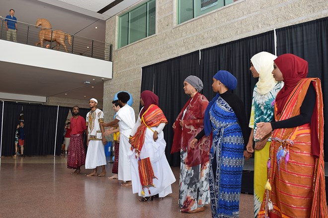 The models show off a variety of Somali clothes. The girl in the centre is wearing a traditional wedding dress.