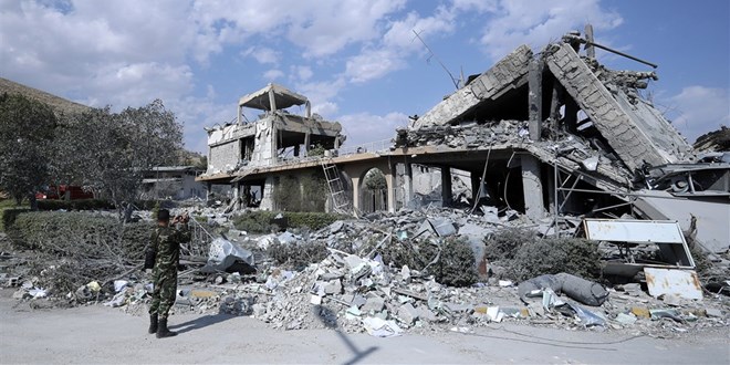 A Syrian soldier records damage at the Syrian Scientific Research Center on Saturday after U.S., British and French military strikes in Barzeh, near Damascus.Hassan Ammar / AP