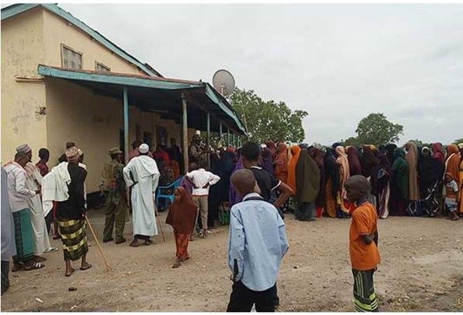 Residents queue at Kotile Dispensary as they receive treatment from KDF personnel. Most public health centres in the area have closed down. PHOTO | KALUME KAZUNGU | NATION MEDIA GROUP