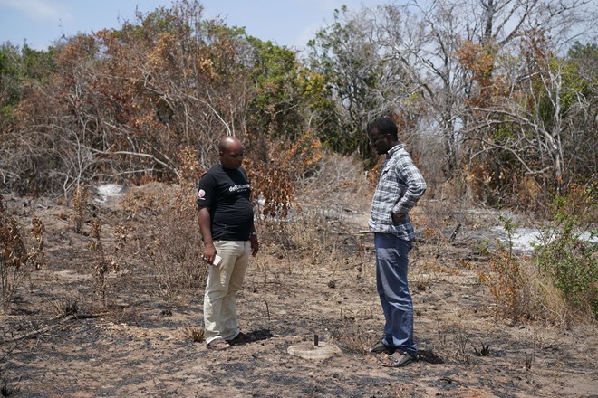 Walid Ahmed Ali, left, an activist with Save Lamu, and a fellow campaigner at the proposed coal plant site. The concrete disc demarcates the construction zone. Credit Joao Silva/The New York Times