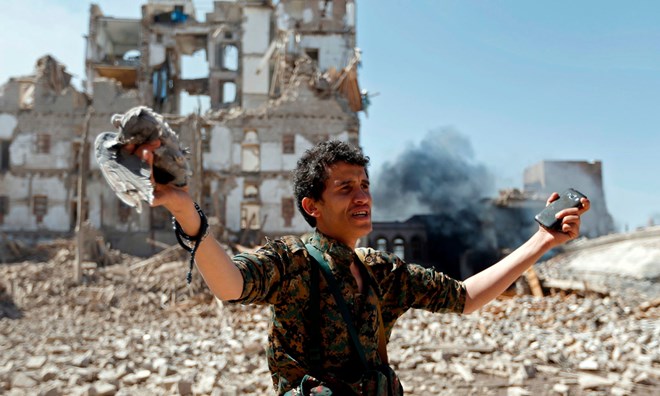 A Huthi rebel inspects bomb damage in Sana’a, Yemen.
Photograph: AFP/Getty Images