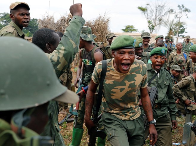 Government soldiers before an attack on rebels in Kimbau, the Democratic Republic of Congo.
Photograph: Goran Tomasevic/Reuters