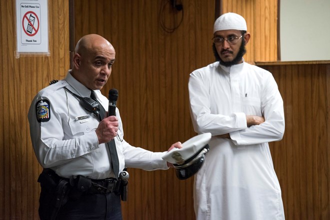 In this Feb. 23, 2018, New American Diversity and Inclusion Officer Khaled Bhagat, with the Columbus Police Department, speaks to members at the Masjid Ibnu Taymiyah Islamic Center after Friday prayer in Columbus, Ohio. Bhagat has been tapped in Ohio’s capital to bridge gaps between police and the city’s growing immigrant population. (AP Photo/Ty Wright)