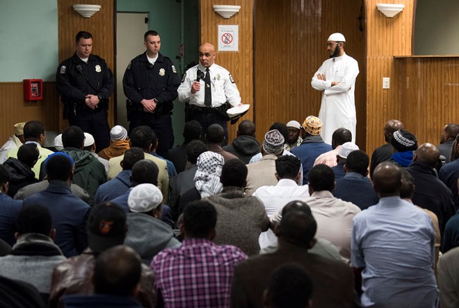 In this Feb. 23, 2018, New American Diversity and Inclusion Officer Khaled Bhagat, with the Columbus Police Department, speaks to members at the Masjid Ibnu Taymiyah Islamic Center after Friday prayer in Columbus, Ohio. Bhagat has been tapped in Ohio’s capital to bridge gaps between police and the city’s growing immigrant population. (AP Photo/Ty Wright)