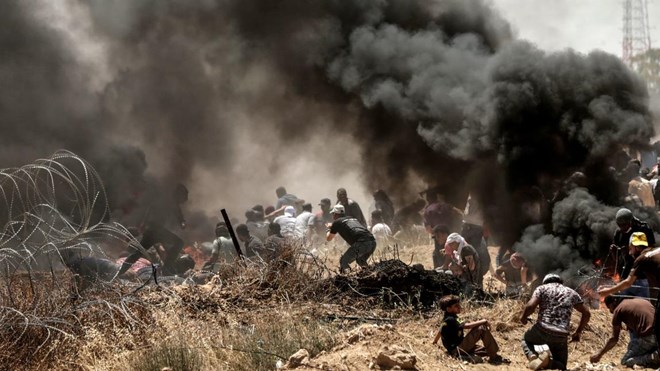 Palestinians clash with Israeli forces near the border between the Gaza strip and Israel east of Gaza City on May 14, 2018, as Palestinians protest over the inauguration of the US embassy following its controversial move to Jerusalem.