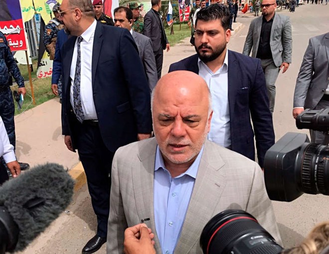 Iraq Prime Minister Haider al-Abadi speaks to reporters after casting his ballot in the country's parliamentary elections in Baghdad on Saturday. His party came in third place. (Associated Press)